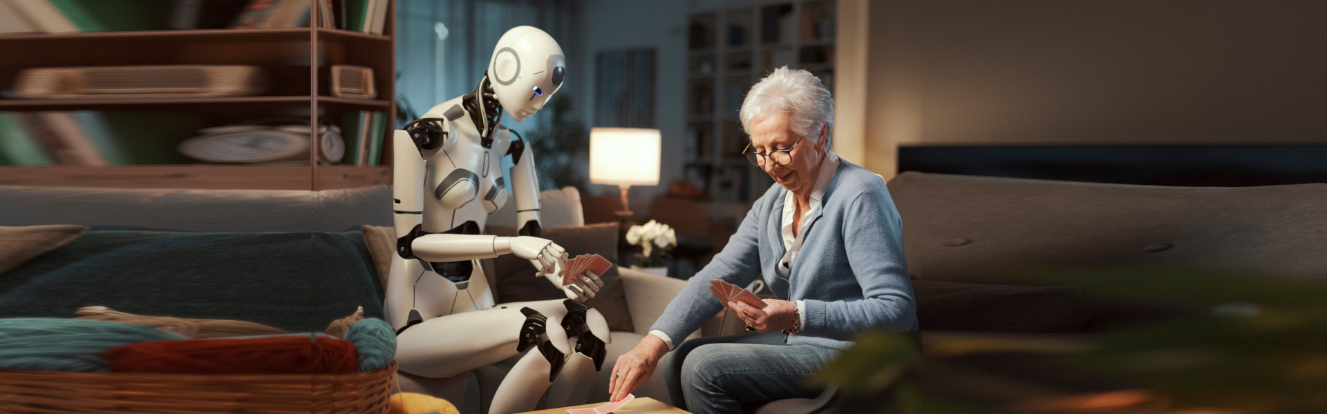 A robot is playing with an old lady.
